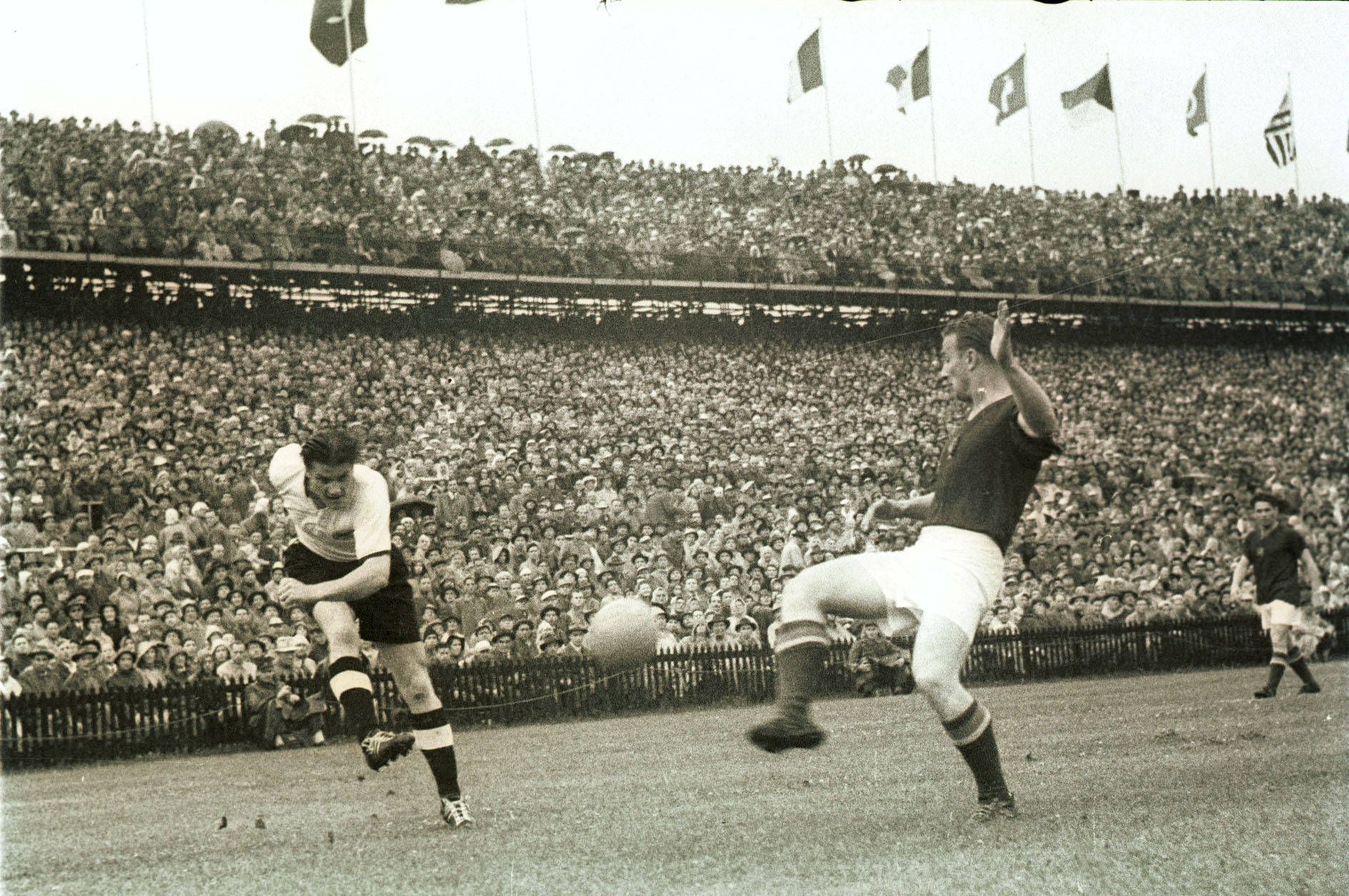 Ottmar Walter headers the ball during the 1954 World Cup final between Germany and Hungary.